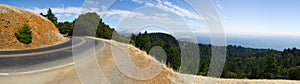 Panorama of mountain road with fog and the ocean