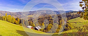 Panorama of a mountain vale in autumn colors