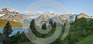 Panorama of mountains in Glacier National Park above Lower Two Medicine Lake in the morning photo