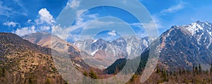 Panorama of mountains and glaciers under blue cloudy sky panoramic