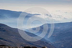 Panorama of mountains that intersect with fog and a sea of low clouds in the background in Sierra Nevada photo
