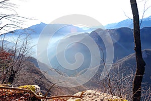 panorama of the mountains of northern Italy against the light with a little mist