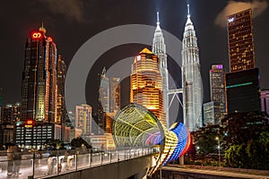 Panorama of the multicolor Saloma link bridge against a pure dark sky of the Kuala Lumpur late night and cityscape