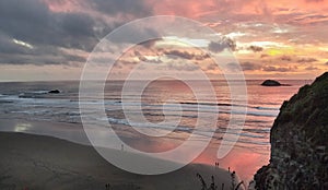 Panorama of Muriwai beach. Sunset under stormy sky