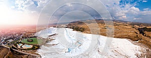 Panorama Natural travertine pools blue water in Pamukkale Turkey aerial top view with sunlight