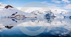 Panorama of Neko Harbor and Lester Cove with glaciers and red te