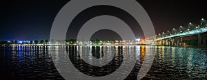 Panorama of night city embankment on left bank of river Don of Rostov-on-Don