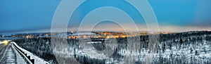 Panorama - the night city of Murmansk, a road along the coast of the Kola Bay.
