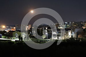 Panorama notturno di Benevento con luna piena photo