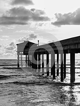 panorama of ocean sunset with concrete jetty