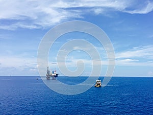 Panorama of offshore drilling rig with supply boat