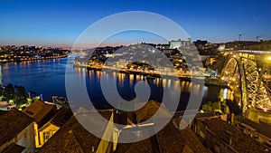 Panorama old city Porto at river Duoro,with Port transporting boats after sunset day to night timelapse, Oporto