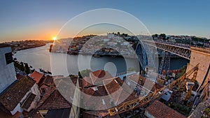 Panorama old city Porto at river Duoro,with Port transporting boats at sunset timelapse, Oporto, Portugal