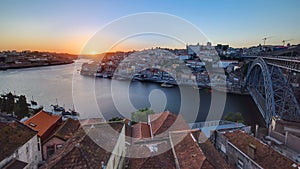 Panorama old city Porto at river Duoro,with Port transporting boats at sunset timelapse, Oporto, Portugal