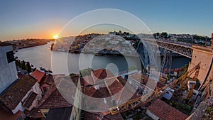 Panorama of old city Porto at river Duoro,with Port transporting boats at sunset timelapse, Oporto, Portugal