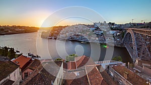 Panorama of old city Porto at river Duoro,with Port transporting boats at sunset timelapse, Oporto, Portugal