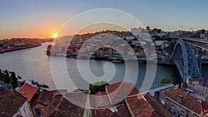 Panorama of old city Porto at river Duoro,with Port transporting boats at sunset timelapse, Oporto, Portugal