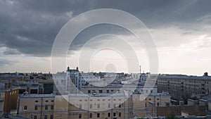 Panorama of old town with gray roofs in cloudy weather. Action. Historical and unremarkable center of city with old photo