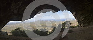 Panorama of outback Australia and deserted roads overlooking spectacular coastline from inside cave at Frenchman Peak near Esperan