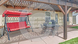 Panorama Outdoor patio of a house with loung seats and covered barbecue griller
