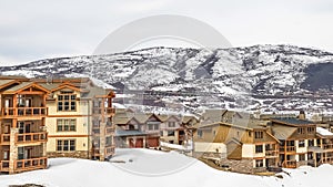 Panorama Panoramic view of homes with balconies and surrounded with snow in winter