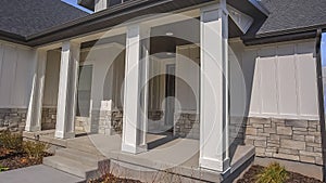 Panorama Pathway and stairs leading to the porch with pillars at the facade of a home