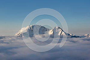 Panorama of the peaks of the Caucasus range towering above the clouds