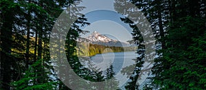 Panorama peering through trees to see Lost Lake and Mount Hood