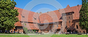 Panorama of people in the courtyard of castle Malbork