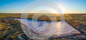 Panorama of pink salt lake Hardy at sunset.