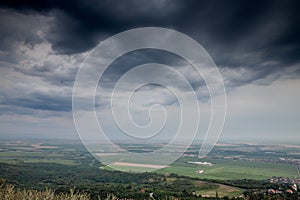 panorama of plains of Vojvodina seen from the Vrsacki Breg, or Vrsac hill, a major landmark in Eastern Serbia under a cloudy sky.