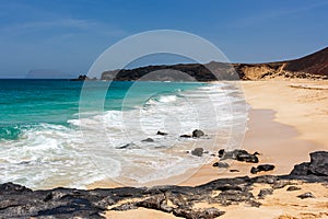 Panorama of Playa de las Conchas beach with blue ocean and white sand. La Graciosa, Lanzarote, Canary Islands, Spain.