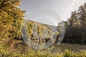 Panorama of the pond Jankovac, a small water lake surrounded by trees and forest in the Papuk mountain, a major national park of