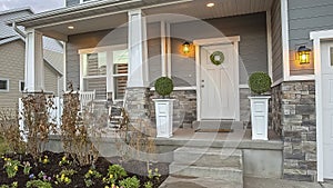 Panorama Porch and yard at the facade of a home with stairs leading to the front door