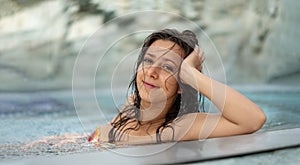 Panorama portrait of beautiful young natural sexy woman with dark hair relaxes contend happy in colorful flower bikini in holidays