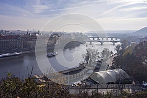 Panorama of Prague capital city in morning fog with Vltava bridges
