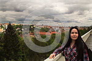 Panorama of Prague. Portrait of young brunette woman.