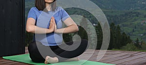 Panorama of pregnant woman practicing meditation on home patio