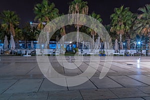 Panorama of promenade in Malaga, Parmeral de las Sorpresas at late night in the full colors of the night city lights. photo