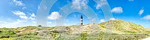 Panorama - red white lighthouse on the north sea