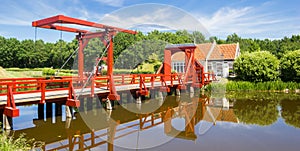 Panorama of a red wooden bridge in historic village Bourtange