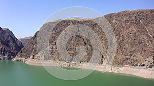 Panorama of the reservoir, rocky mountains, hills and quarry. A beautiful lake in the mountains.