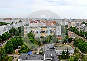 Panorama of residential areas of the summer city in the early morning from the height of the 16th floor of a residential building.