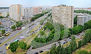 Panorama of residential areas of the summer city in the early morning from the height of the 16th floor of a residential building.