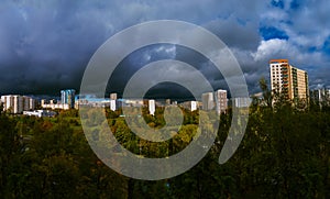Panorama of residential disctrict of Moscow at autumn with beautiful dark rainy clouds in the blue sky photo