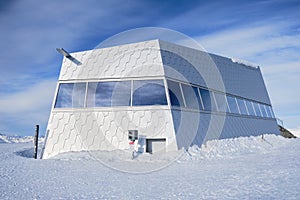 Panorama restaurant on Weisshorn summit, in Winter, a modern looking building in the Swiss Alps. Arosa, Switzerland.