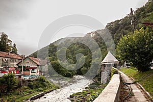 Panorama of the river Cerna in Baile Herculane, Romania, with individual houses and spa and thermal baths in the middle of the