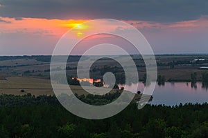 Panorama of the river, fields and forests on the background of a sunset