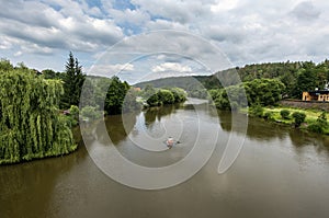 Panorama of river Sazava with green shores and sailing canoe