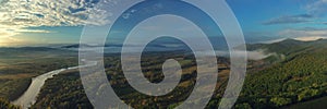 Panorama of the river valley. Morning fog . The mountains on the horizon.